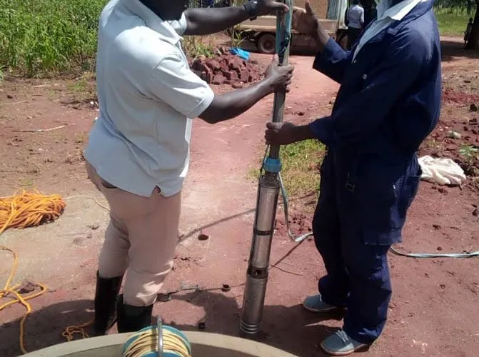 Geo Drilling team installing a pump on site